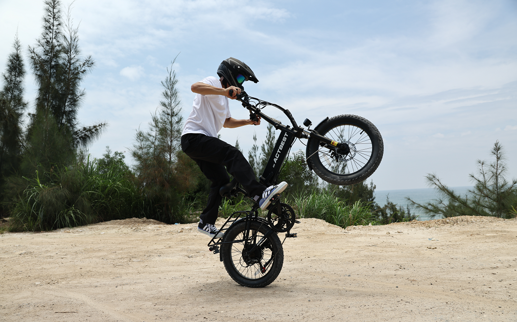 Rider riding a full suspension electric bike on a mountain road