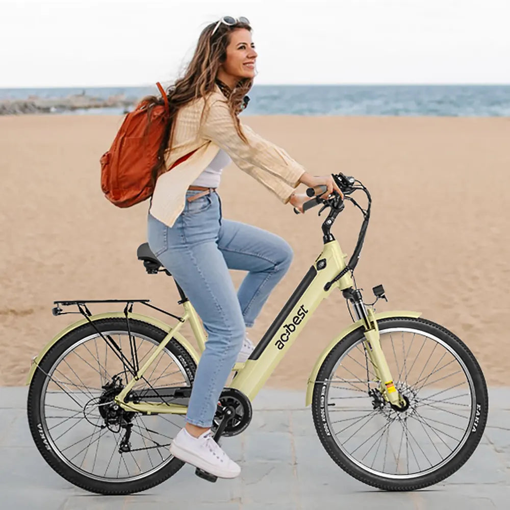Light yellow step-thru electric bike with front suspension on beach path