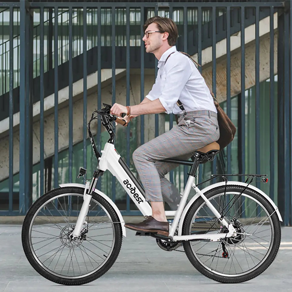 Man riding a white step-thru electric bike with front suspension.