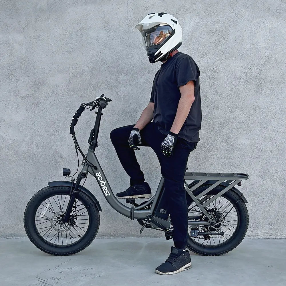Male rider on grey Mars Folding Electric Bike with fat tires and rear cargo rack.