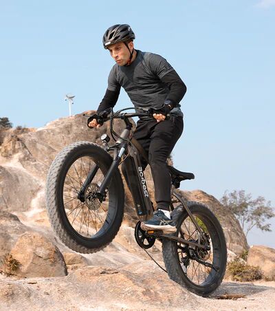 Person riding a mountain bike on rocks.