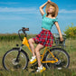 Woman with plaid skirt on yellow Actbest Step-Through Electric Bike in grassy field.