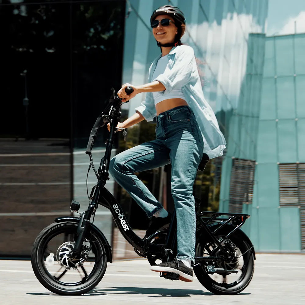 Woman riding a foldable black Actbest electric bike in city setting