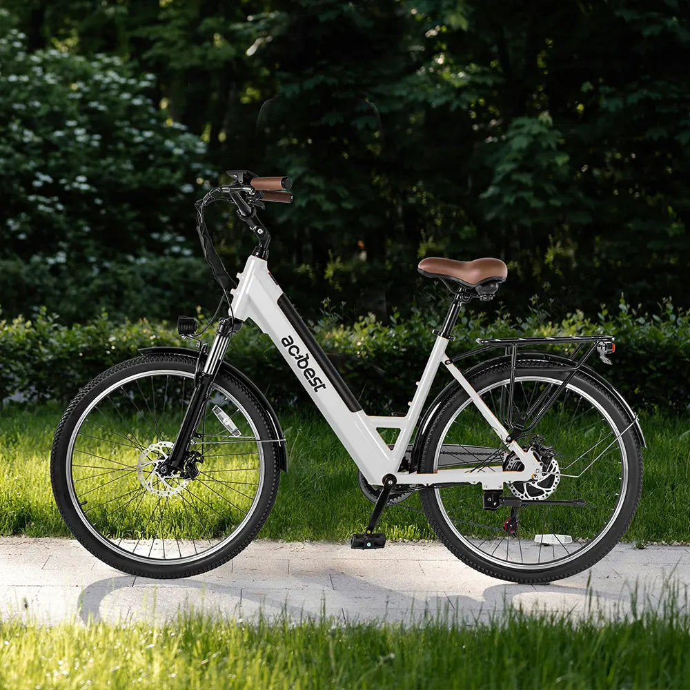 White Actbest Core Step-Through Electric Bike with brown seat in a green park.