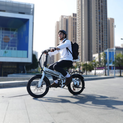 Rider on a foldable electric bike with fat tires in an urban setting.