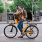 Man in a brown jacket standing with yellow Actbest Step-Through Electric Bike.