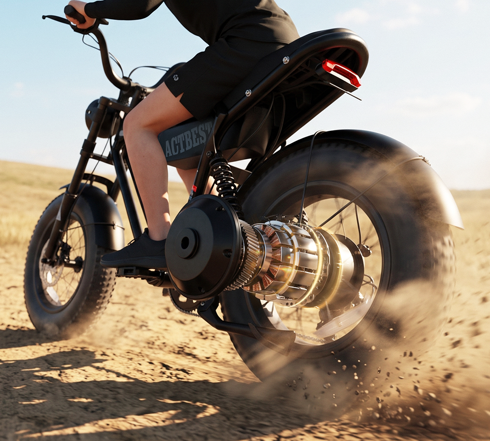 A person riding a black electric fat-tire ebike on a sandy desert road, kicking up dust. The bike has a large rear wheel, a visible metallic motor assembly, and the brand name 'ACTEDES' printed on the side panel.